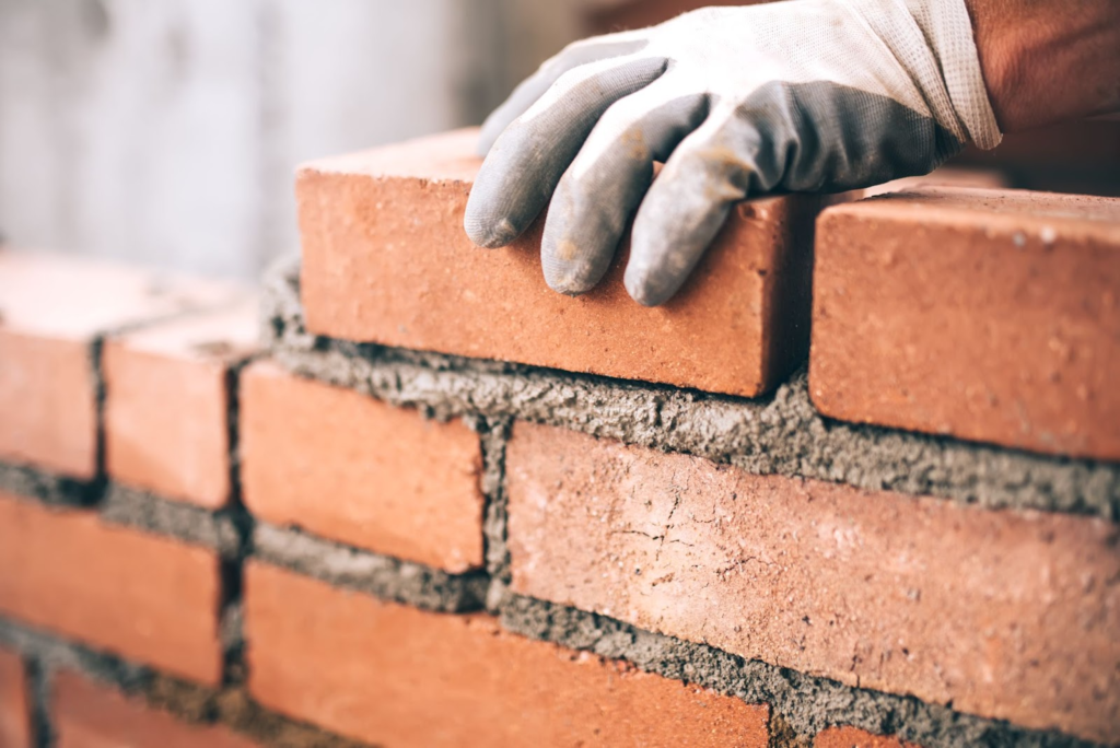 A brick layer continues to work on a construction site in Canada.